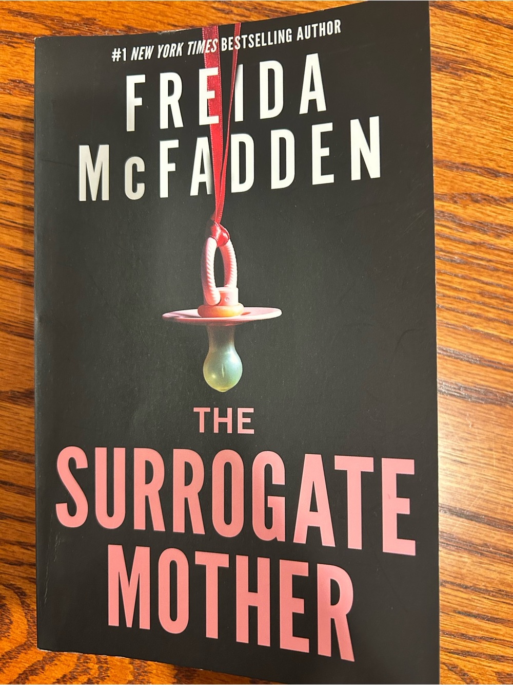 The Surrogate Mother by Freida McFadden - Black & Pink Paperback